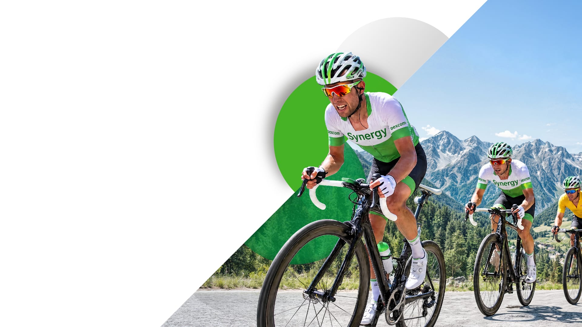 Three riders in white-and-green Synergy kit climbing an alpine mountain pass, the lead rider out of the saddle in front of a green disc.